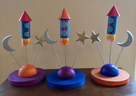 Out of this World carnival centerpieces... 3 down, 21 to go! Rocket Ship Centerpiece Space Theme, Out Of This World Centerpieces, Rocket Centerpiece Space Party, Astronaut Theme Centerpiece, Space Centerpiece Ideas Birthday, Outer Space Table Centerpieces, Space Themed Centerpieces Diy, Spaceship Centerpiece, Space Birthday Centerpieces