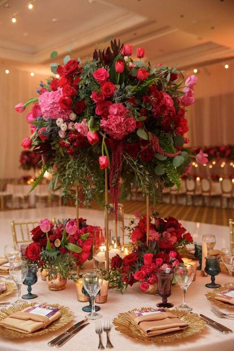 Romantic, floral centerpiece - tall, red and pink centerpieces with roses, tulips and greenery - Find your florist on WeddingWire! {Vanessa Jaimes Floral Design} Shades Of Pink Floral Centerpiece, Pinks And Burgundy Wedding, White Pink Red Wedding, Red Roses Reception Decor, Wedding Centerpieces Red Roses, Blush Pink Red And White Wedding, Pink Red Wedding Decor, Pink And Red Flowers Wedding, Pink And Burgundy Centerpieces