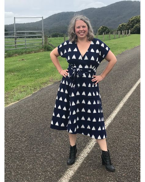 Kate is smiling and stands with her hands on her hips on a road surrounded by her lush green farm property with mountains in the background. She is wearing a handmade navy wrap dress with white triangles Elodie Wrap Dress, Sewing Practice, Learning A New Skill, Another Dimension, Learn A New Skill, Sewing Blogs, Ikat Fabric, Social Worker, Christmas Dress