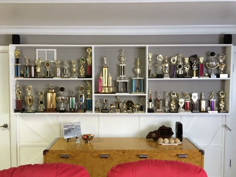 Trophy shelves. I laid the trophies out before nailing the shelves in place. Trophy Decor Ideas, Trophy Stand Display, Office Trophy Display Ideas, Small Trophy Room Ideas, How To Display Trophies, Trophy Display Ideas Living Room, Trophy Display Ideas Shelves, Shelves For Trophies, Trophy Shelf Ideas Interior Design