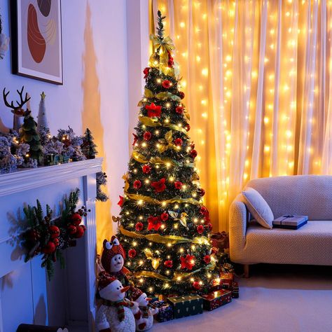 PRE-LIT Christmas Tree: This 6-foot-tall Christmas tree comes with 200 warm white LEDs that are evenly distributed throughout the tree, so you don't need to buy additional LED strings to decorate it. This bright Christmas lighting makes the whole night very cozy
With Christmas Decorations: The tree is pre-decorated with gold ribbons, bows, flowers, and also comes with 40 red Christmas balls that can be decorated on the tree according to your needs. Pre Decorated Christmas Tree, Warm Christmas Decor, Pop Up Christmas Tree, 6ft Christmas Tree, Colored Led Lights, Warm Christmas, Beautiful Christmas Trees, Holiday Party Decorations, Christmas Tree Lighting