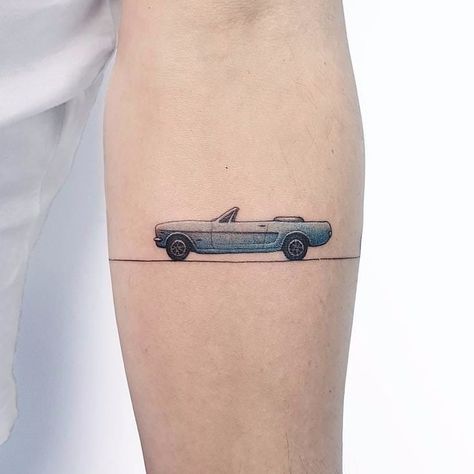 tattoodo | Tiny car tattoo by Ahmet Cambaz #AhmetCambaz #color #small #minimalism #realism #realistic #car #sportscar #linework #cuff #cartattoo #tattoooftheday | Tattoodo Cartoon Car Tattoos, Car Related Tattoos For Men, Classic Car Tattoo, Simple Car Tattoo, Vintage Car Tattoo, Car Lover Tattoo, Car Tattoo Ideas, Tattoo Ideas Simple, Mechanic Tattoo