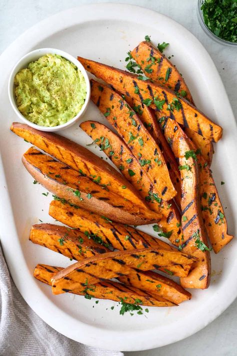 Grilled sweet potato wedges are a delicious and easy-to-make BBQ side dish with a crispy charred exterior that's fluffy on the inside. | How to Grill Sweet Potato Wedges | Grilled Sweet Potatoes | Grilled Sweet Potato Wedges | Grilled Potato Recipe | Sweet Potato On Grill, Mediterranean Hummus, Batata Harra, Air Fryer Sweet Potato Fries, Spicy Potatoes, Garlic Smashed Potatoes, Smashed Sweet Potatoes, Ground Chicken Burgers, Feel Good Foodie