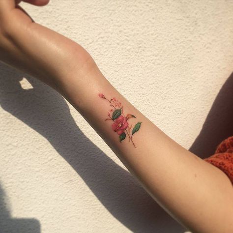 Camellia flower tattoo on the wrist. Camellia Flower Tattoo, Dainty Flower Tattoos, Love Wrist Tattoo, Wrist Tattoos Words, Hibiscus Flower Tattoos, Delicate Tattoos For Women, Meaningful Wrist Tattoos, Hibiscus Tattoo, Girls With Sleeve Tattoos