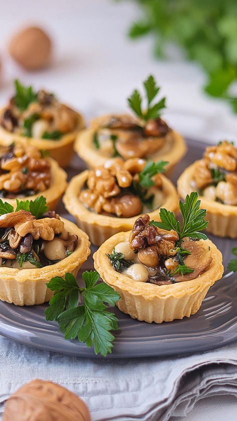 These elegant mini tarts are a delightful treat for any fancy gathering. Featuring a savory blend of finely chopped mushrooms and walnuts, combined with fresh herbs, all encased in a flaky vegan pastry crust, these tarts are baked to perfection until golden and aromatic. Mini Tarts Recipe, Mini Tart Recipes, Vegan Appetizers Recipes, Vegan Appetizer, Zucchini Bites, Mini Tarts, Vegan Pastries, Tarts Recipe, Vegan Mushroom