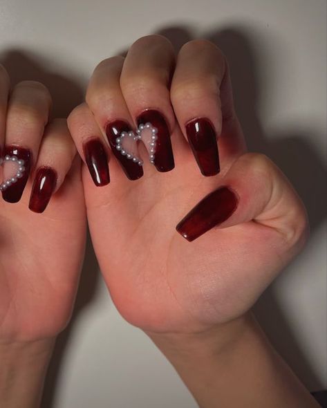 pearl heart red nails #nails #naildesign #nailartistry #nailart #manicure #pedicure #nailsofinstagram #instanails #naillenspiration #nailtrends #nailgoals #prettynails #cutenails #fancynails #acrylicnails #gelnails #longnails #shorthnails #Valentine'sdaynails #Valentine'sday Burgundy Nails With Pearls, Dark Red Nails With Pearls, Valentines Day Nails Dark Red, Dark Red Jelly Nails, Dark Red Coffin Nails, Red Nails With Pearls, Heart Red Nails, Spring Nails Acrylic Coffin Long, Red Pearl Nails