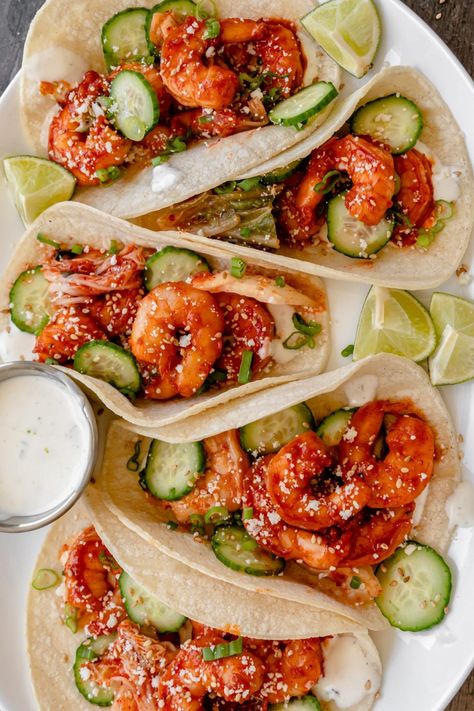 These easy Korean Shrimp Tacos have spicy marinaded shrimp and an easy lime cream sauce. Top it with whatever your heart desires - but I recommend cucumber, kimchi, and green onion. These healthy Asian fusion tacos are great for a crowd and perfect for summer! Gochujang Shrimp, Korean Shrimp, Lime Cream Sauce, Fusion Tacos, Korean Cream, Cucumber Kimchi, Shrimp Marinade, Healthy Asian, Creamed Cucumbers