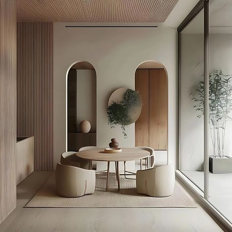 An effortlessly elegant dining space in Japandi style, characterised by clean lines, light wood furnishings, and pastel hues. A round table takes center stage, flanked by two semicircular chairs on each side, alluding to the room’s balance and harmony. The wooden ceiling, adorned with slats, echoes the natural warmth found throughout, while floor-to-ceiling windows offer vistas of lush greenery outside, inviting a sense of serenity indoors. A potted plant adds a touch of organic life to the... Japandi Color Palette, Japandi Dining Room, Japandi Dining, Small Office Design Interior, Japandi Interior Design, Small Office Design, Japandi Home, Japandi Design, Japandi Interior