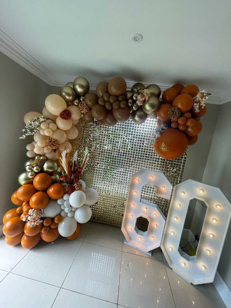 Burnt Orange balloon display with gold sequin wall and light up numbers Orange And Brown Balloon Garland, Burnt Orange Decorations Party, Burnt Orange Balloon Arch, Burnt Orange Birthday Party, Orange And Silver Party Decorations, Terracotta Balloon Garland, Orange And Gold Birthday Decorations, Orange And Gold Party Decor, Burnt Orange Balloon Garland