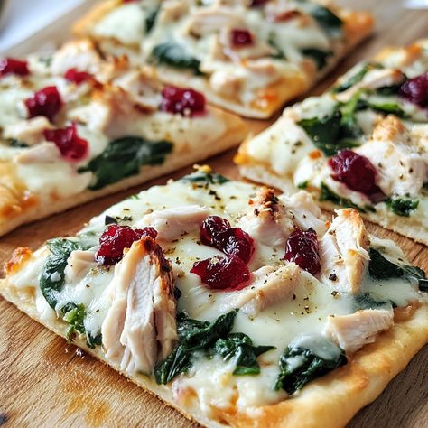 Enjoy a delightful twist on leftovers with this Turkey Cranberry Flatbread! 🥪🍂 A tasty and quick meal option!" Turkey Cranberry Flatbread Ingredients: Flatbread (2 pieces) Cooked turkey (1 cup, shredded) Cranberry sauce (½ cup) Cream cheese (4 oz) Spinach (1 cup, fresh) Mozzarella cheese (½ cup, shredded) Olive oil (1 tbsp) Salt and pepper (to taste) Instructions: Preheat oven to 375°F (190°C). Spread cream cheese evenly over flatbreads. Layer turkey, cranberry sauce, spinach, and mozzare... Turkey Cranberry Wraps Recipes, Cranberry Flatbread, Turkey Cranberry, Instagram Recipes, Brie Cheese, Quick Meal, Trending Recipes, Cooking Turkey, Fresh Mozzarella