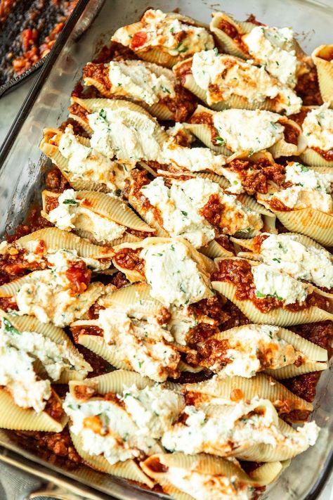 If you want dinner to be a hit for everyone in the family, these Stuffed Shells will do the trick. They’re large pasta shells, stuffed with a delicious slow-cooked meat sauce and plenty of gooey cheese. Top off the entire dish with even more cheese, and you have a winning meal. #stuffedshells #pasta Large Stuffed Shells Recipes, Stuffed Shells Meat Sauce, Large Shells Recipe, Meat Filled Stuffed Shells, Large Shells Stuffed, Brisket Stuffed Shells, Stuffed Pasta Shells With Meat, Big Pasta Shells Stuffed, Cheese Stuffed Shells With Meat Sauce