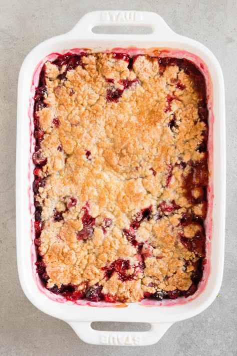 This super easy Cranberry Cobbler dessert recipe is made with sweetened fresh cranberries, orange juice and zest, and a sweet crunchy topping. #cobbler #cranberry #orange #recipe #easy #best #fresh #holidays #dessert Cherry Rhubarb Crisp, Cranberry Orange Desserts, Cherry Rhubarb, Orange Recipes Dessert, Cranberry Cobbler, Fresh Cranberry Recipes, Orange Recipe, Crisp Desserts, Cherry Crisp