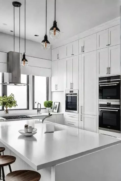 Minimalist white kitchen with clean lines and modern appliances Modern Kitchen Cabinets Ideas, Kitchen Island Luxury, Minimalist White Kitchen, White Modern Kitchen Ideas, Luxury Kitchens Mansions, Contemporary White Kitchen, Luxury Kitchen Island, Kitchen Decoration Ideas, Kitchen Remodeling Ideas