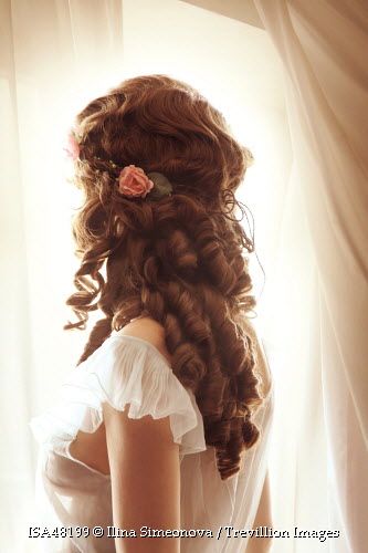 Trevillion Images - brunette-woman-standing-by-window Bridgerton Hairstyles, 1800s Hairstyles, Historical Hairstyles, Edwardian Hairstyles, Brown Curly Hair, Victorian Hairstyles, Romantic Hairstyles, Flowers In Her Hair, Brunette Woman