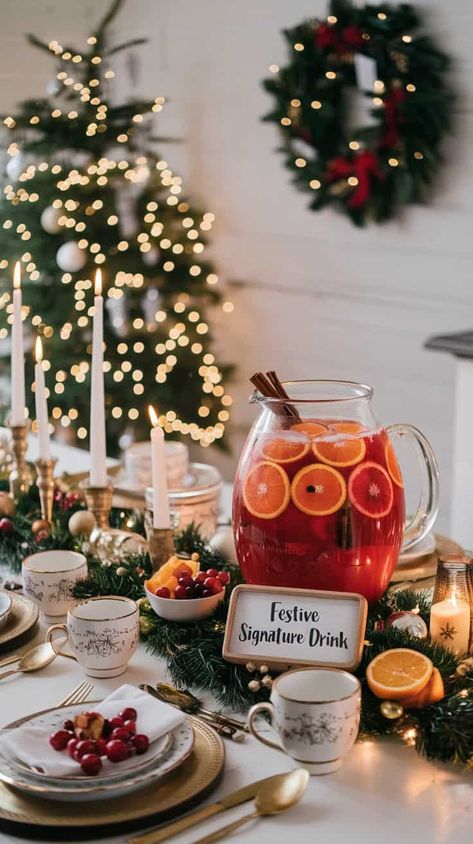 18 Best Christmas Party Ideas Festive holiday table with a signature drink, candles, and Christmas decor for a cozy seasonal celebration. | Sky Rye Design Christmas Party Serving Table Ideas, Cocktail Christmas Party Decor, Christmas Party Bar Ideas, Christmas Dinner Party Ideas Decor, Christmas Eve Table Decorations, Hosting Christmas Dinner Decor, Christmas Dinner Ideas Decoration, Posada Party, Christmas Party Set Up