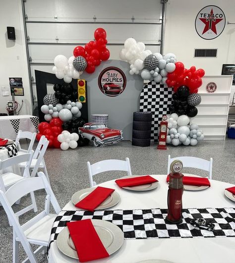 Nicole Creations Houston on Instagram: "Classic cars and dinner theme This is the coolest garage I’ve seen! My clients grandparent was awesome. He took us back to 1950s Amazing place! Baby Holmes is on his way! Thanks to Victoria and family for choosing us #eventplanner #houstondecorator #balloongarland #babyshower #kidsparty #itsaboy #classiccartheme #houstonbackdrops #elvis #1955chevybelair" Racing Theme Backdrop, Racing Theme Birthday Party Decorations, Classic Car 1st Birthday Party, Classic Car Birthday Party Decorations, Garage Theme Birthday Party, Race Track Theme Birthday Party, Vintage Car Party Theme, Cars Themed Baby Shower Ideas, Car Theme Centerpiece Ideas