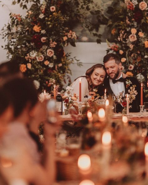 A rich autumnal palette creates for a romantic and modern wedding atmosphere 🍂💫 A canopy of lush foliage, flickering candles, and elegant blooms brought an intimate, cosy atmosphere to life, wrapping the day in timeless romance. Soft neutrals paired with rich burgundies, deep reds, soft peaches, and vibrant oranges - a seasonal colour combo that’s elegant, timeless, and utterly swoon-worthy. The pièce de résistance? The whimsical ceremony arch, beautifully repurposed as a stunning backdro... Whimsical Ceremony, Autumnal Palette, Burgundy Colour Palette, Luxury Florists, Wedding Flower Inspiration, Flickering Candles, Colour Combo, Ceremony Arch, Vibrant Orange