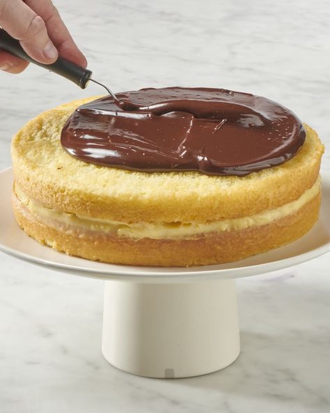 a whole boston cream pie on a cake stand being topped with chocolate ganache Boston Cream Pie Recipe, Fluffy Sponge Cake, Boston Cream Cake, Cake Themes, Traditional Desserts, Pie Designs, Choctaw Nation, Pastry Cream Filling, Waffle Cookies