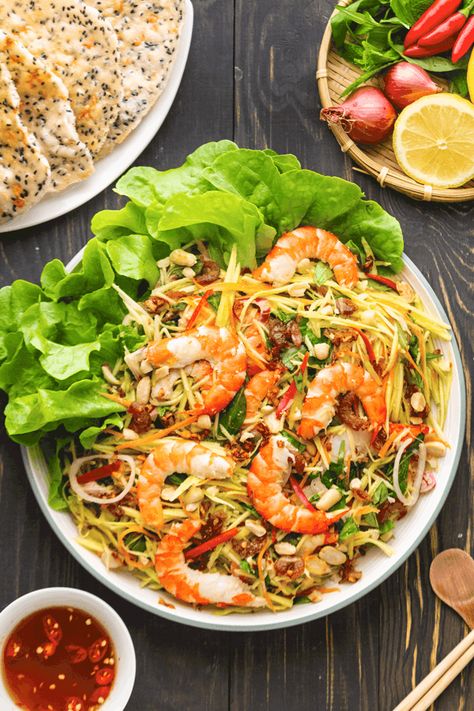 You won't find a salad more fresh than our Vietnamese Mango Salad! The shredded fruit and vegetables give the perfect amount of crunch. It pairs beautifully with succulent prawns and is infused with a classic sweet and savory dressing that makes it tasty AND healthy! #mangosalad #vietnamesemangosalad #vietnamesesalad Vietnamese Noodle Salad, Classic Dressing, Vietnamese Noodles, Summer Recipes Dinner, Seafood Salad, Mango Salad, Grilled Shrimp, Vietnamese Recipes, Summer Dinner