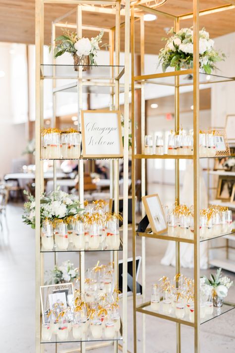 Champagne Toast Display, Champagne Welcome Table Wedding, Welcome Champagne Wall, Unique Wedding Displays, Welcome Drink Display, Champagne Display Ideas, Champagne Bookshelf Wedding, Wedding Drink Display, Champagne Welcome Table