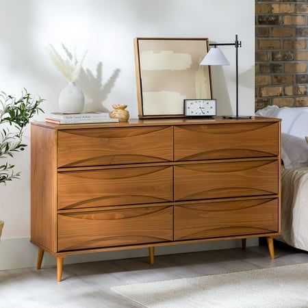 Add a stylish and practical dresser to your home with the Walker Edison 58 Mid-Century Modern Curved Front 6-Drawer Dresser. This eye-catching dresser features unique, curved detailing on the front of the drawers, which gives it a retro-inspired look that is sure to stand out. The tapered legs add an extra touch of style, while the six spacious drawers provide plenty of room for storing the essentials. Made from responsibly harvested solid pine wood, this dresser is both environmentally friendly and long-lasting. Color: Brown.