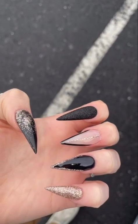 Black Christmas Nails Stiletto, January Nails Stiletto, All Black Stiletto Nails, Black And Gold Sparkly Nails, Black And Sparkle Acrylic Nails, Long Black Nails Stilettos, New Years Stilleto Nails, Stilleto Nails Christmas Designs, Black Glitter Stiletto Nails