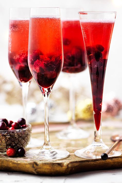 Festive fruit gives this Kir Royale an extra special twist. With a syrup made from cranberries, Crème de Cassis and sugar this Champagne cocktail is the perfect Christmas party idea. | Tesco Cocktail Recipes Christmas, Healthy Cocktail Recipes, Cranberry Drinks, New Years Cocktails, Kir Royale, Dinner Party Desserts, Drinks Ideas, Champagne Cocktails, Healthy Cocktails