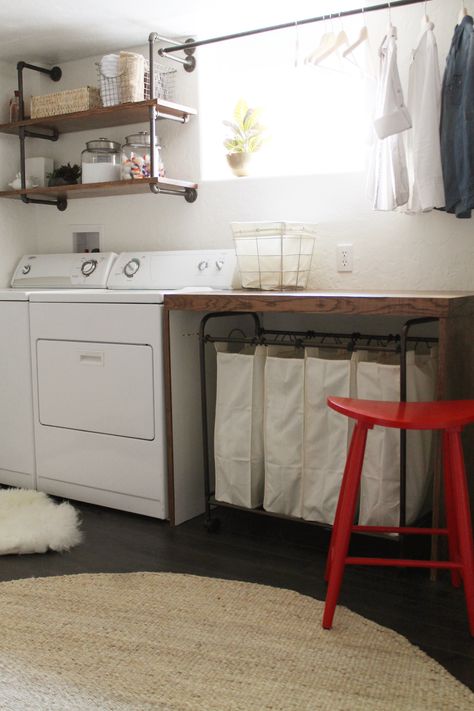 basement laundry room -- I like the simplicity of this room, the wooden folding table, the shelves over the washer/dryer, the drying rack, the laundry sorter under the table (genius, then you don't have to see the messy laundry!), and the bright red stool Functional Basement, Laundry Room Organization Storage, Casa Clean, Room Storage Diy, Basement Laundry Room, Basement Laundry, Farmhouse Laundry Room, Small Basements, Laundry Room Remodel