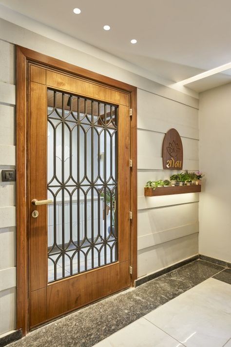 Chic Door Design, Door Design Modern With Jali, Home Entry Door Design, Main Door Side Wall Design, Safety Door Design Entrance Modern For Flat, Flat Entry Door Design, Entry Door Design Modern, Main Door Jali Design Entrance Modern, Kitchen Entry Door