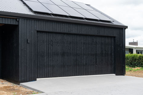 Detail in the design. This dream home for clients in Waikato includes a custom charred cladding garage door. Cladded Garage, Black Metal Garage, Cladding Garage, Charred Cladding, Fowler Homes, Bungalow Ideas, Garage Plans Detached, Pod House, Modern Garage