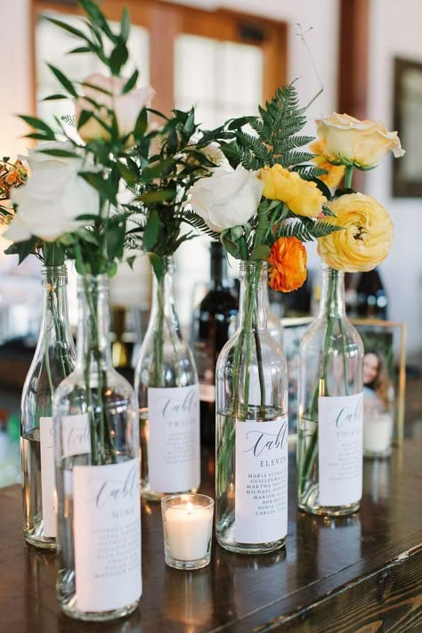 wine bottles. seating plans wedding decor diy Charming Wedding Reception Tables Of Wine Barrels | sustainable | Eco-friendly wedding | Wedding Table Number Idea | Wine Bottle Table Numbers | rustic wedding | Elegant wedding | Cork decorations | Unique Wedding Ideas | Seating ideas | DIY Wedding Ideas #rusticwedding #weddinginspo #vineyardwedding #weddinginthewoods #rustic weddings Unique Wedding Ideas Diy, Wine Bottle Wedding Decor, Wine Bottle Table Numbers, Creative Wedding Table Numbers, Bottle Table Numbers, Wine Bottle Table, Wine Bottle Centerpieces, Wedding Wine Bottles, Diy Wedding Table