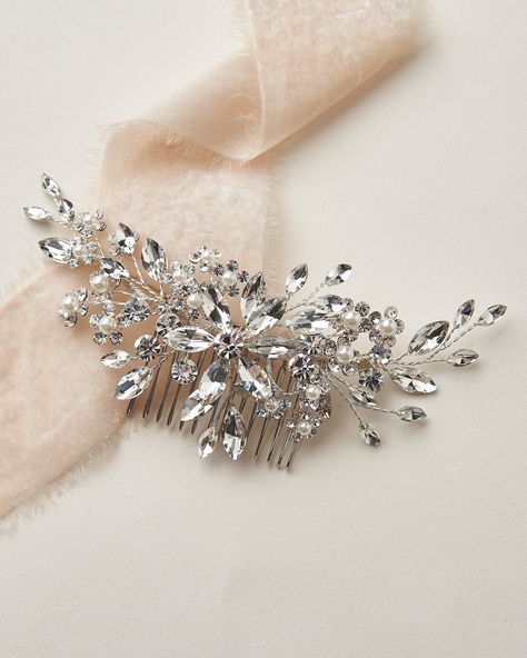 STELLA BRIDAL COMB (TC-2408) Steal the spotlight with our Stella Bridal Comb. Stella is a bold, floral design with no shortage of sparkle. Hand wired crystals and pearl accents make this comb lightweight & easy to style. DETAILS * Hand wired with crystal gemstones and dainty off white pearls. * Measures 6 x 3 inches. * Metal comb is wired to the back of the design. * Finish: silver. * Versatile & flexible, this piece can be worn in the back of nearly any hairstyle and the hand wired branches can Pearl Bridal Comb, Diy Hair Accessories Ribbon, Wedding Comb, Wedding Hair Head Piece, Floral Hair Pieces, Organizing Hair Accessories, Floral Comb, Bridal Hair Headpiece, Hair Accessories Boho