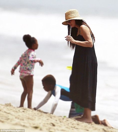 The heat's on: With thermometers in Los Angeles soaring to 98F, concerned mom Sandra Bullock took her children Louis, eight, and Laila, six, to cool off on beach in Malibu on Sunday Sandra Bullock Kids, Sandy Bullock, Famous Families, Adopted Children, Teen Stuff, Popular Actresses, Celebrity Families, Children Playing, Black And White Love