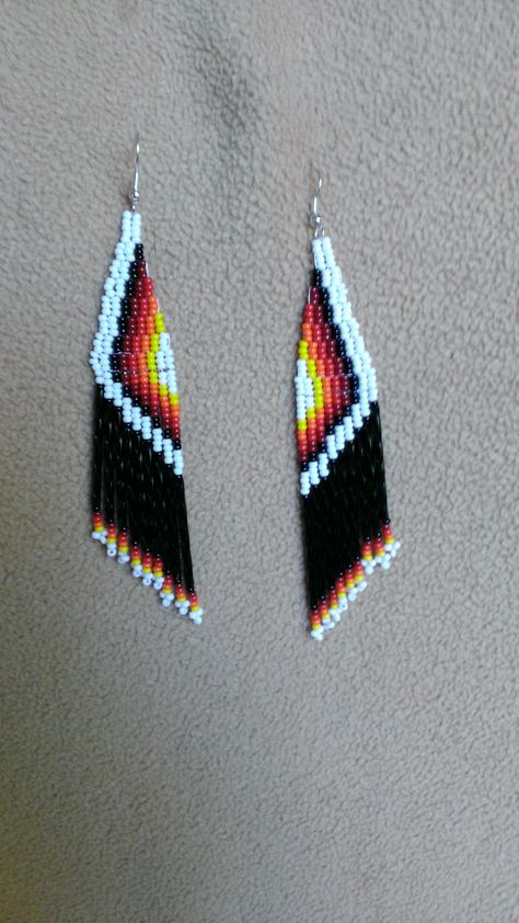 PLEASE BUY WITH CONFIDENCE ALL ITEMS ARE HAND BEADED BY ME AND NOT IMPORTED FROM OVERSEAS. THESE COME FROM A SMOKE-FREE HOME. MY PRICES ARE LOW BUT YOU WILL GET THE HIGHEST OF QUALITY WORK.  These beautiful earrings are made with seed beads and the colors are  Black,White, Yellow, Red , Orange  with glass bugle beads they are 4 inches long  If you have any questions please feel free to drop me a line thanks utonya4@gmail.com asking price 18.00 Bugle Beaded Earrings, Loom Beaded Necklace, Flame Earrings, Miyuki Beads Pattern, Seed Bead Jewelry Patterns, Seed Bead Crafts, Native Beadwork, Brick Stitch Earrings, Beaded Jewelry Tutorials