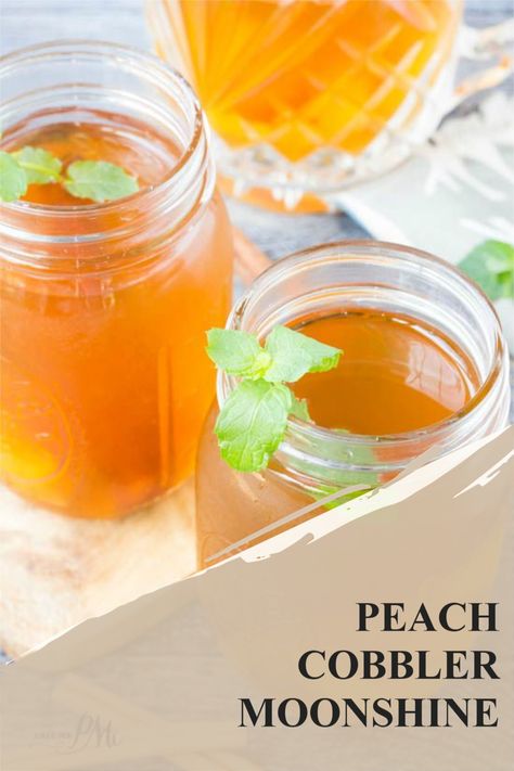 Peach Cobbler Moonshine, aka Peach Moonshine, is slightly sweet, has a little kick, and is a delicious cocktail whether on its own or added to mixed drinks. By using fresh or canned peaches you can enjoy this party staple all year. Peach Pie Alcohol Drink, Peach Cobbler Moonshine, Peach Moonshine Cocktails, Peach Cobbler Moonshine Recipe, Moonshine Drink Recipes, Peach Moonshine, Moonshine Cocktails, Moonshine Recipe, Peach Cocktail