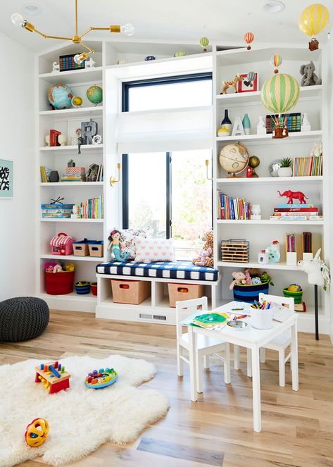 Design a space where kids can have fun and be creative with these tips for decorating a playroom. Whether you have a basement, attic, or corner of a room, these playroom design ideas deliver toy storage solutions, furniture arrangements, and fun color schemes both parents and children will love. These kids’ playroom ideas are sure to spark your inspiration. #toystorage #kidsplayroomideas #kidsroomdesign #playroom #playroomideas #bhg Playroom Vintage, Diy Bookshelves, Window Nook, Caitlin Wilson, Blogger Home, Playroom Storage, Playroom Design, Toy Rooms, Check Fabric