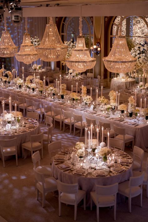 Room with five crystal chandeliers, round banquet tables and family style table set with tall lit tapered candles, white florals and placesettings at a wedding reception. California Winter Wedding, Luxury Wedding Reception, Luxury Weddings Reception, Elegant Winter Wedding, Wedding Furniture, Wedding Themes Winter, All White Wedding, Event Lighting, Wedding Receptions