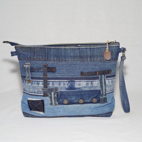 The cosmetic bag is made from recycled materials, specifically from pieces of old denim jeans, which contributes to environmental conservation by reducing waste and utilizing existing resources.  The bag is lined with cotton fabric, ensuring additional durability and quality.  It also features a small handle for easy carrying. It closes with a metal zipper, ensuring security and practicality. Dimensions Width: 30cm Height: 21cm Depth: 6cm Each piece that you will find in the collection is made o Quilted Bag Patterns, Patchwork Purse, Jean Purses, Repurposed Denim, Diy Bags Purses, Reducing Waste, Environmental Conservation, Recycle Jeans, Jeans Bag