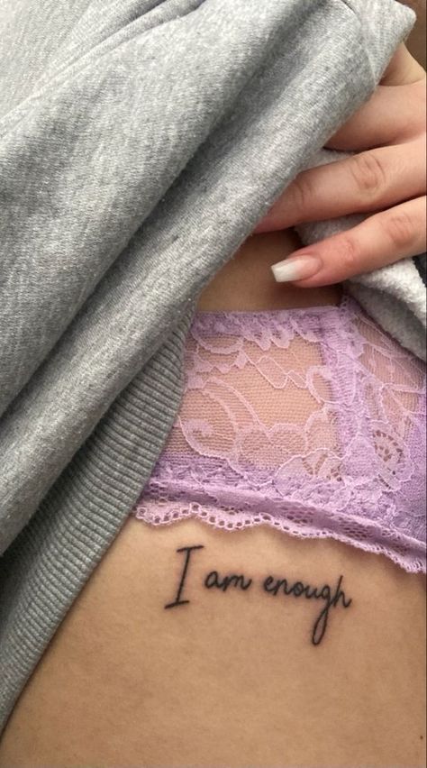 Welcome to the world of the ‘I am enough’ tattoo, a design that speaks volumes. This design is not just a fleeting trend. It serves as a powerful affirmation, a daily reminder of your intrinsic worth. No Tattoo Quotes, Love Yourself Back Tattoo, Tattoos For Self Confidence, Tattoo For Body Confidence, I Am Enough Rib Tattoo, Body Empowerment Tattoos, Tattoos For Confidence, Tattoos To Keep You Going, Self Worth Tattoo Ideas