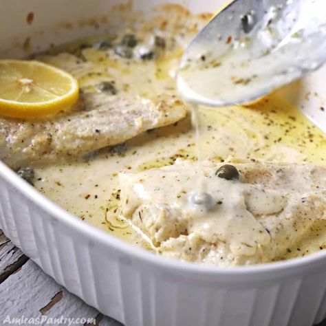 A spoon scooping some creamy sauce over the fish in a white pan. Easy Baked Fish Recipes, Fried Tilapia Recipes, Creamy Lemon Sauce, Fish Fillet Recipe, Baked Fish Fillet, Lemon Cream Sauces, Fish Recipes Baked, Baked Fish Recipes, Flavorful Vegetables