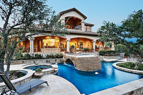 Love this unique pool design...the bridge/waterfall combination, hot tub and landscaping are spectacular. Elevated Hot Tub, Desert Pools, Mediterranean Pool, Luxurious Pool, Hill Country Homes, Mediterranean Style Homes, Casas Coloniales, Dream Pools, Spanish House