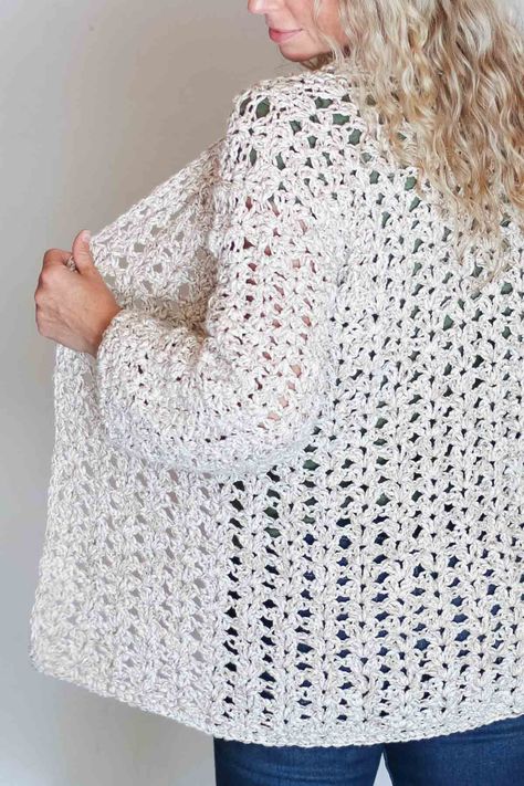 The back of a blonde woman wearing a casual crochet cardigan made with the iris stitch and Lion Brand Twisted Cotton Blend yarn. Crochet Jackets For Women, Crochet Cardigans For Women, Crochet Light Cardigan Pattern, Free Crochet Pattern Sweaters & Cardigans, Crochet Cardigan Pattern Free Women Easy, Fitted Crochet Cardigan Pattern, Crochet Cardigan Ideas, Easy Crochet Cardigan, Fitted Casual Crochet Cardigan