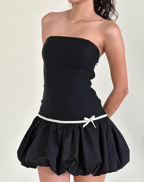 The Klaita mini dress in black features a bandeau neckline and bodycon fit with drop waist and puffball skirt. Finished with binding and decorative bow in white. MODEL WEARS SIZE:EXTRA SMALL - MODEL HEIGHT:5'7 Drop Waist Dress Mini, Nice Mini Dress, Short Black Puffy Dress, Dropped Waist Skirt, Black And White Bow Dress, Drop Waist Mini Dress, Bubble Skirt Dress, Baloon Dress, Birthday Core