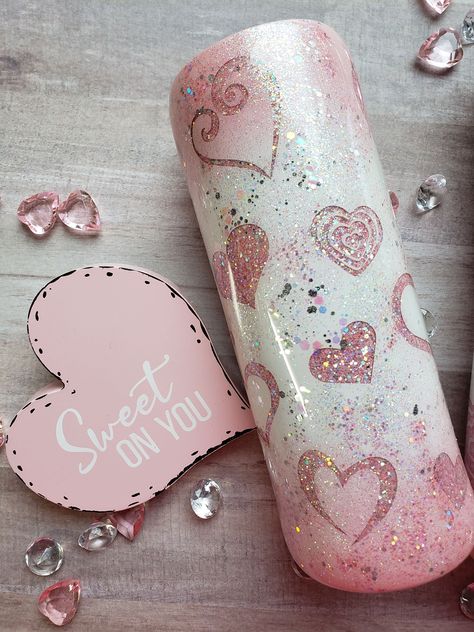 This beautiful sweetheart tumbler is sure to spark the love for yourself or that special someone. This tumbler comes with multiple peek-a-boo hearts and the sparkle of lots of glitter. The pink and white ombre is absolutely beautiful. My favorite color is pink and I believe this is one of the prettiest tumblers I have ever made. All my tumblers come with a sliding lid and a reusable straw. This tumbler can also be personalized with your name or a special heart with your name and that special som Pink And White Glitter Tumbler, Pink Glitter Epoxy Tumbler, Prettiest Tumblers, Girly Tumbler Cups, Resin Cups Ideas, Glitter Cups Tumblers, Heart Tumblers, Peekaboo Tumbler, Pink And White Ombre