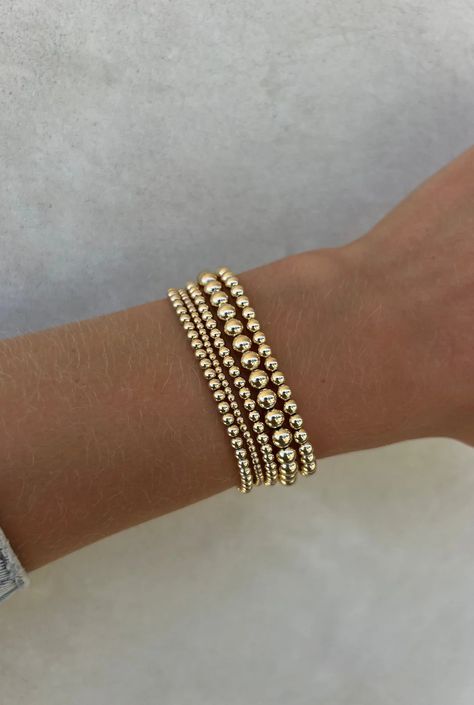 This curated stack consists of a mixture of 5 signature bracelets. (1) 2MM Yellow Gold Filled Beaded Bracelet (2) 3MM Yellow Gold Filled Beaded Bracelets (1) 4MM Yellow Gold Filled Beaded Bracelet  (1) 5MM Yellow Gold Filled Beaded Bracelet DETAILS: 14k Yellow Gold Non-tarnish & water safe Size: 5.75-8", XXS-XXXL 6 Gold Filled Bracelet Stack, Liza Gozlan Bracelets, Gold Beaded Bracelets Stack, Gold Bead Bracelet Stack, Braclets Gold, Gold Bracelet Stack, Gold Beaded Bracelets, Jewelry Stack, Gold Bracelets Stacked