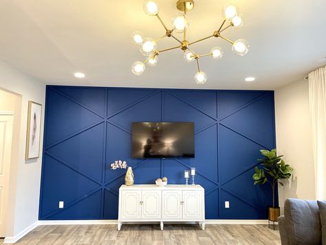 Royal blue geometric accent wall.  This wall is the attraction of this living room.  The spunk chandelier adds some glam to the whole look. Royal Blue Wall Paint Bedroom, Royal Blue Walls Bedroom, Royal Blue Accents Living Room, Living Room Designs Royal Blue, Royal Blue Accent Wall Living Room, Royal Blue Walls Living Room, Royal Blue Accent Wall Bedroom, Royal Blue Wall Paint, Royal Blue Interior Design