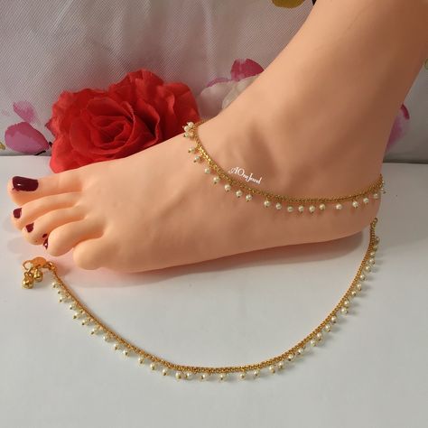 Beautiful handcrafted Indian gold plated hanging pearl pair of anklets traditionally called payals or ghanjar. Stunning design anklets. It is a beautiful ornament worn around the ankle. You can worn it on one foot or as a pair on both feet. It is sure to make your feets look beautiful. Length: 27.5 cm Main Colour: Gold Pearl Colour: Ivory Closer: Hook clasp with bells. Package Includes: 1 pair of anklets Payal Designs Gold, Indian Gold Anklet, Indian Anklets Gold, Gold Anklet Designs, Gold Payal Design Indian Anklets, Gold Anklets Indian, Sangeet Jewellery, Bollywood Style Gold Anklets For Festive Occasions, Festive Gold Bollywood Anklets