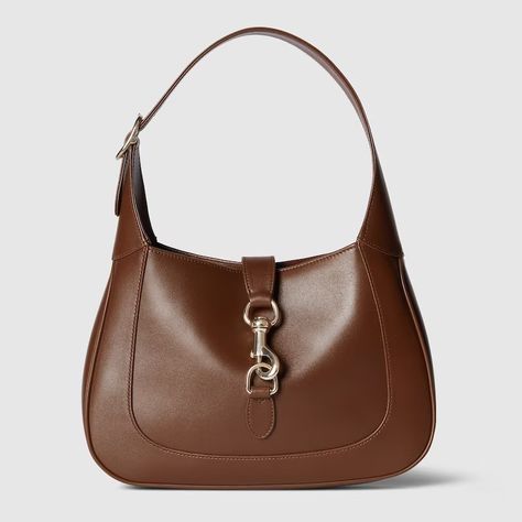 Gucci Jackie small shoulder bag in brown leather | GUCCI® International Jackie Brown, Gucci Store, Red Web, Crescent Shape, Zip Puller, Brown Bags, Green And Red, Gucci Handbags, Small Shoulder Bag