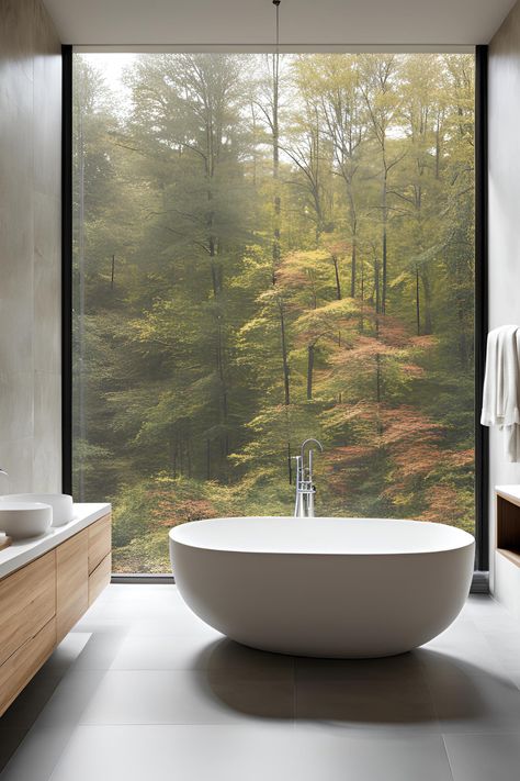 Modern, bathroom with a view. The beauty of having a big windows. Clean lines, minimalist fixtures & light colors create a spacious feel. #modernbathroom #contemporarybathroom #minimalistbathroom #modernbathroomideas #modernbathroomdesigns #modernbathroominspo #contemporarybathroomideas #contemporarybathroomdesigns #contemporarybathroominspo #minimalistbathroomideas #minimalistbathroomdesigns #minimalistbathroominspo #modernbathrooms #contemporaybathrooms #minimalistbathrooms Bathrooms With Big Windows, Big Bathroom Window, Big Window In Bathroom, Soaking Tub In Front Of Window, Big Window Bathroom, Bathroom With Big Window, Bathtub In Front Of Window, Tiny Cottage Bathroom, Rustic Cottage Bathroom