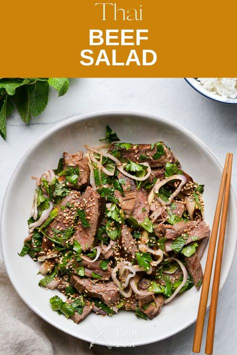 Our recipe for Nam Tok (Thai Beef Salad) is a rich, satisfying dish. Tender, marinated steak bites provide juicy bursts of flavor, mixed with a fresh salad of shallots, green onions, cilantro, and mint. Add some optional fresh sliced chili peppers for an authentic Thai-style heat. You can layer the meat and salad mixture over fragrant Jasmine rice, resulting in a hearty main dish your entire family will love. Thai Beef Salad Dressing, Thai Steak Salad Recipes, Spicy Thai Basil Beef, Authentic Thai Beef Salad Recipe, Thai Waterfall Beef Salad, Roast Beef Salad, Thai Beef Salad Recipe, Steak Salad Recipe, Thai Beef Salad